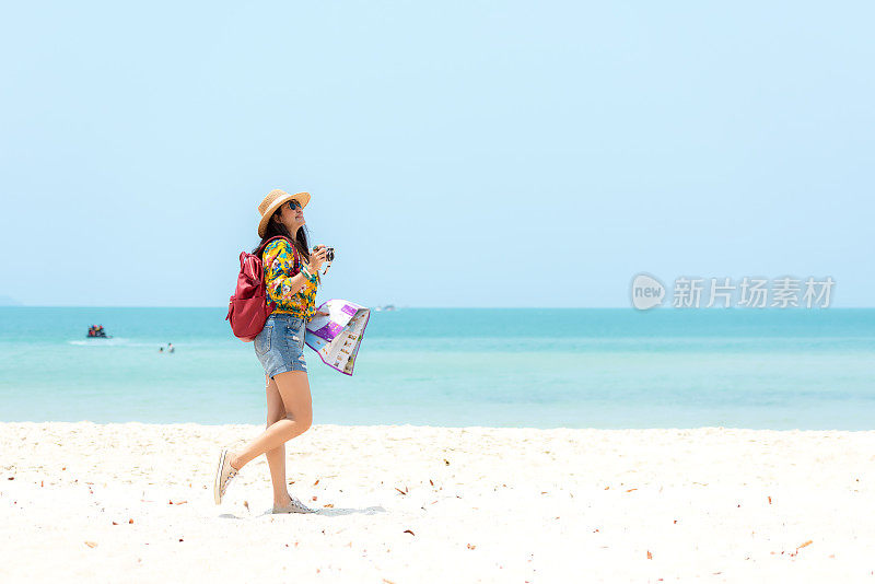 Happy traveler and tourism women travel summer on the beach.  Asian smiling people holding map and camera planning travel trip